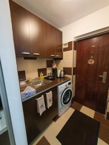 a kitchen with a washing machine and a sink at My Little Room in Constanţa