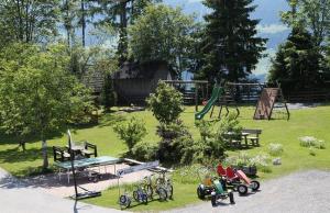 a park with a playground with bikes parked in the grass at Biobauernhof Brandlhof in Ramsau am Dachstein
