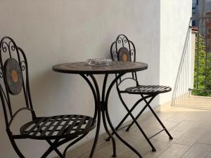 a table and two chairs sitting next to a wall at B&B Le Mansarde in Pescara