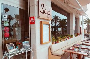 a restaurant with tables and chairs in front of a store at La Sort Boutique Hotel in Moraira