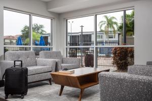 a living room with couches and a table with a suitcase at Orbit One Vacation Villas in Orlando