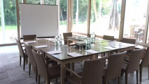 a large wooden table with chairs in a room at Corte San Ruffillo Country Resort in Dovadola