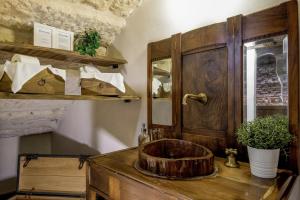 a bathroom with a wooden sink on a wooden table at Dimora Scaligera Luxury Apartment in Verona