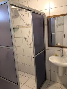 a bathroom with a shower and a sink at Pousada Canto do Boldró in Fernando de Noronha
