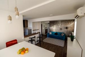 a kitchen and living room with a white table and chairs at Kristall Apartments 2 Panorama in Šabac