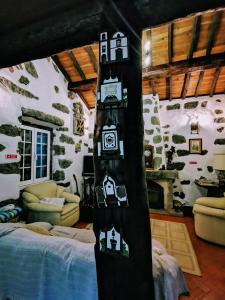 a room with a room with a bed and a fireplace at Casa Santa in Ribeira Grande