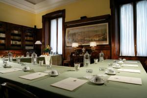 a conference room with a long table with green table cloth at Villa Spalletti Trivelli - Small Luxury Hotels of the World in Rome +37 photos