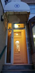 a front door of a house with a sign above it at Hotel Avansi in Blackpool