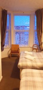 a bedroom with two beds and a window at Hotel Avansi in Blackpool