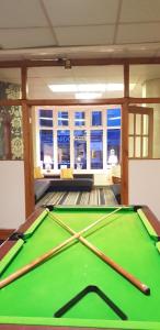 a pool table with three bats on top of it at Hotel Avansi in Blackpool