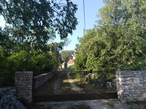 a gate at the entrance to a garden at Family friendly holiday home "Ana" in Šibenik