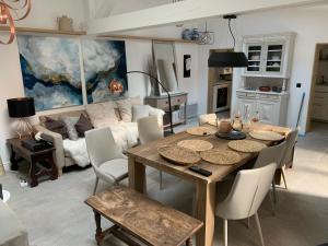 a living room with a table and a couch at Cannes cote sud in Cannes