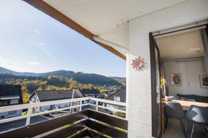 a balcony with a view of the mountains at Apartment Hillebachsee in Winterberg