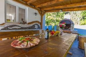 a wooden table with a plate of food on it at Villa Manta Crikvenica in Crikvenica