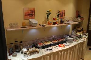 a buffet line with food on top of it at Pension La rose in Brandenburg an der Havel