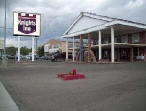 a building with a sign in the middle of a parking lot at Knights Inn Wendover in Wendover