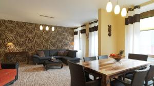 a living room with a table and a couch at Mosella Ferienwohnungen in Bernkastel-Kues