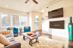 a living room with a couch and a fireplace at Beautiful 3 Bedroom Townhouse in Old Town North, Brewery District in Fort Collins