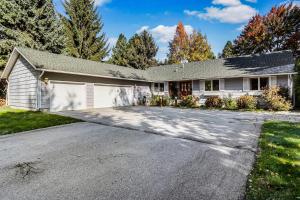 a house with a driveway with a garage at Sandpoint Paradise in Sandpoint