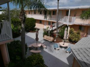 an aerial view of a hotel with benches and palm trees at Cozy Beach Getaway in Cape Canaveral