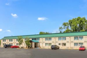 a large building with cars parked in a parking lot at Lotus by Hotel Inn in Boise