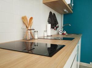 a kitchen with a counter with a glass counter top at Albergue O Peirao in A Guarda