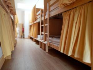 a row of bunk beds in a room at Albergue O Peirao in A Guarda