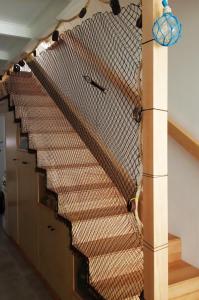 a staircase in a building with a net at Albergue O Peirao in A Guarda