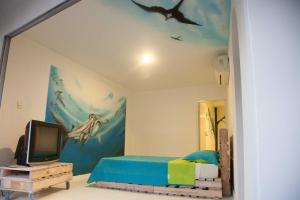 a bedroom with a dolphin painting on the wall at Apartamentos Turísticos In Di Town in San Andrés