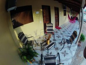 een patio met stoelen, een tafel en een schommel bij pousada jalapão arco iris in Mateiros