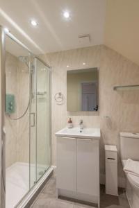 a bathroom with a shower and a sink and a toilet at Aye Stay Home, city centre in Inverness