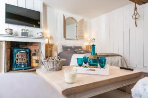una habitación con una cama y una mesa con jarrones. en LE ROMANTICA - Les Suites Romantiques Honfleur en Honfleur
