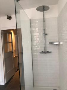 a shower with a glass door in a bathroom at LE ROMANTICA - Les Suites Romantiques Honfleur in Honfleur