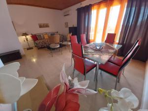 a living room with a dining room table and chairs at Eva Apartments in Svoronata