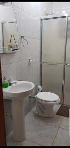 a bathroom with a toilet and a sink and a shower at Casa da Cachoeira in Brotas +20 photos