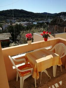 a table and chairs on a balcony with a view at Apartment Neno - 100m from the sea in Sutomišćica