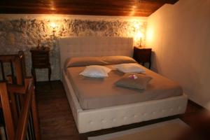 a bedroom with a white bed with two pillows at Acasamia in Cagliari