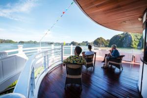 a group of people sitting on the deck of a cruise ship at Starlight Cruise in Ha Long