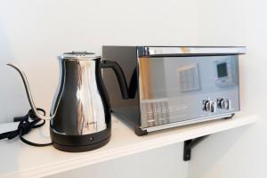 a coffee maker and a microwave on a shelf at MIYABI Highland Terrace Villa A in Fujiyoshida