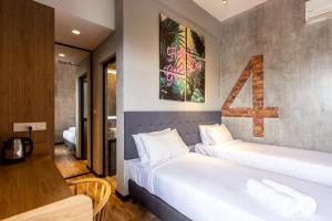 a hotel room with two beds and a table at Brown Hotel in George Town