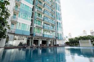 a swimming pool in front of a building at Ivy Thonglor 55 in Bangkok