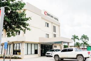 a white truck parked in front of a store at Century Hotel in Garapan