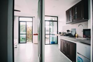 a kitchen with a door leading to a balcony at Good Place in Ko Tao