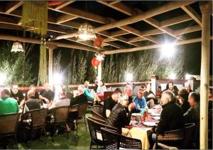 a group of people sitting at tables in a restaurant at Namra Hotel and Camps - Temisgam in Khalatse