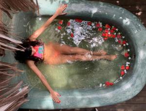 a woman floating in a pool of water at Pousada Spa Oasis in Caraíva +66 photos