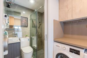 a bathroom with a toilet and a sink and a washing machine at Ensuite King Single Room - AC - Next to Central - Closely Located to Almost Sydney Must Seen Spots in Sydney +34 photos