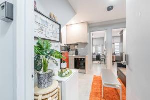 a kitchen with white cabinets and a table with plants at 1 Private Double Bed With En-Suite Bathroom In Sydney CBD Near Train UTS DarlingHar&ICC&C hinatown - ROOM ONLY in Sydney