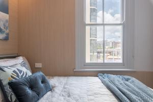 a bedroom with a bed with a large window at 2 Private Double Bed In Sydney CBD Near Train UTS DarlingHar&ICC&C hinatown - ROOM ONLY in Sydney