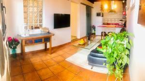 a living room with a table and a tv at SUNSET IN LOFT in Playa Honda