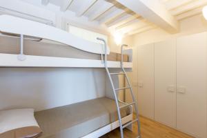 a bunk bed in a room with a ladder at Rio Marina Charme e Relax in Rio Marina